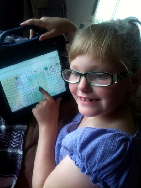 Kiara Chamzuk, 7, shows off her Vantage Lite, which helps her communicate with her friends, family and teachers.