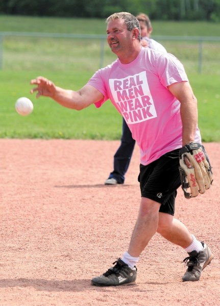 Ron Chamzuk, captain of Team Catherine, throws a pitch at the Breast Friends slow pitch tournament and fundraiser in Busby last weekend. The tournament raised more than