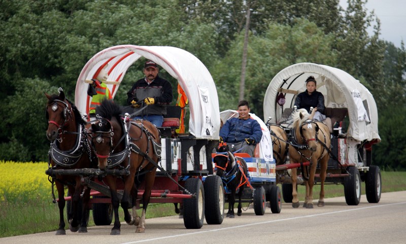 The Merrier family from Cadotte Lake, led by George Merrier, drive their horses and wagons south along Highway 44 July 12 en route to Lac Ste. Anne for the July 16-21 Lac