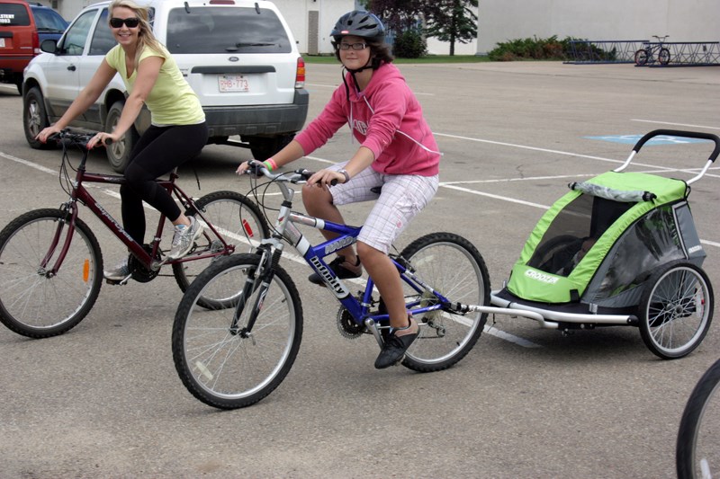 Carley Krahn (left) and Monica Krahn, along with nine-month-old Sarina Darroch, set off from the Westlock Recreation Centre last Saturday. The rode the 10-kilometre Rotary