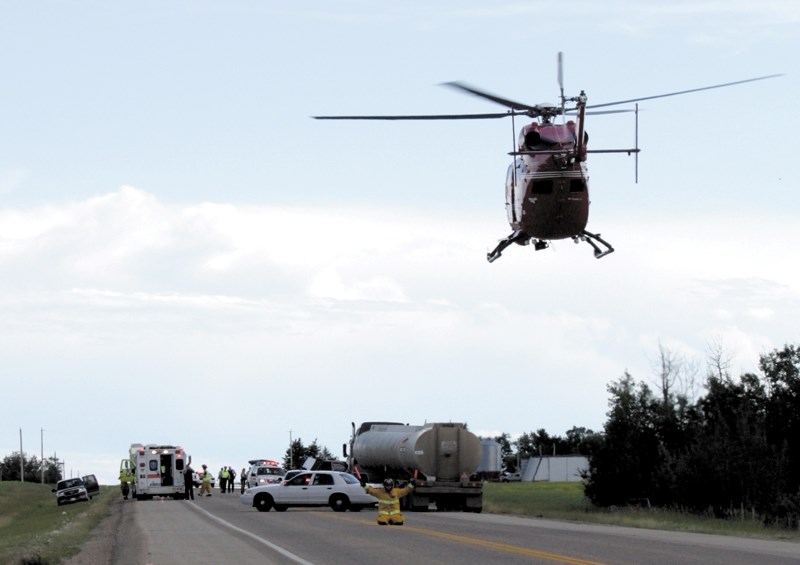 A member of the Sturgeon County Fire Department helps to land the STARS air ambulance after a three-vehicle collision on Highway 44 just south of the Westlock County line