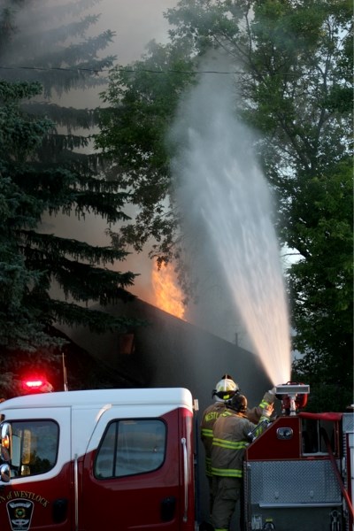 Westlock firefighters fight a house fire in the early morning hours of July 25. The home was destroyed in the blaze.
