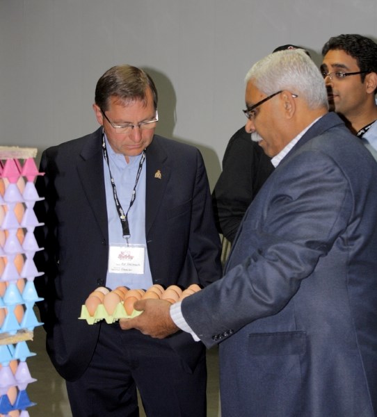 Sparks Eggs owner Meb Gilani shows Premier Ed Stelmach some of the eggs produced by the chickens at the Severson Free Run Barn in southeast Westlock County during an open