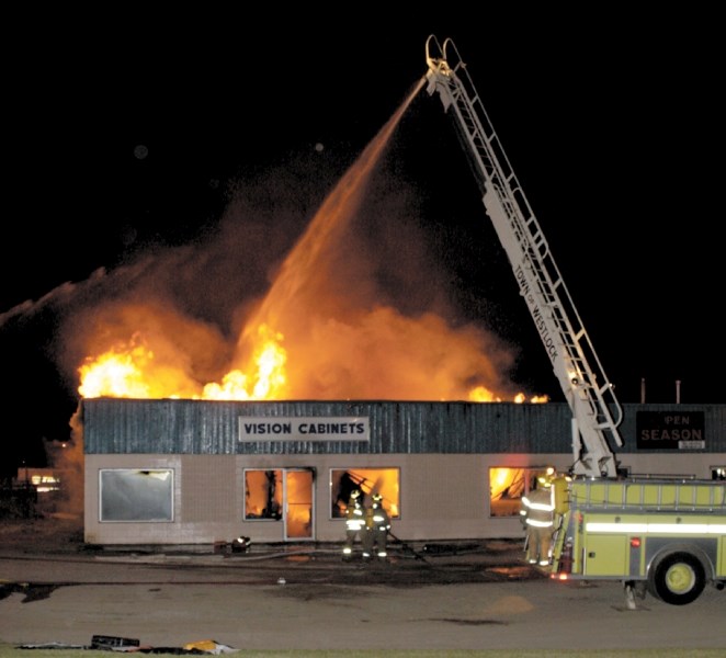 Firefighters work to contain the blaze that destroyed Vision Cabinets last Wednesday night. Crews were on scene until early Thursday morning putting out hot spots.