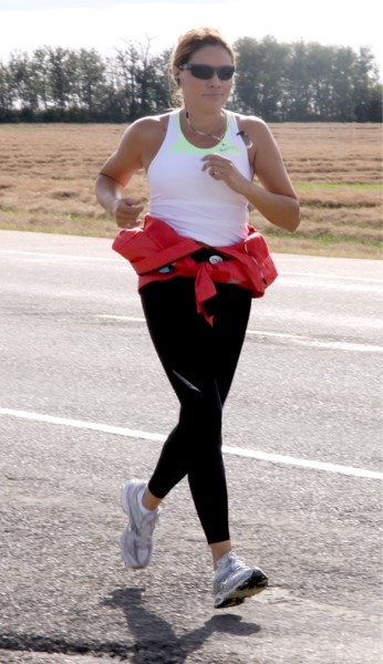 Cleo Carifelle makes her way to Westlock along Highway 44 on Sunday, Sept. 18 as part of her run to thank the communities which pitched in during the disaster in Slave Lake.