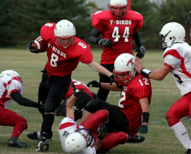Running back Thane Marshall (12) helps block for wide receiver Eric Hardinge (8) after he caught a short pass from quarterback Kurtis Ouellette (44) during the Westlock