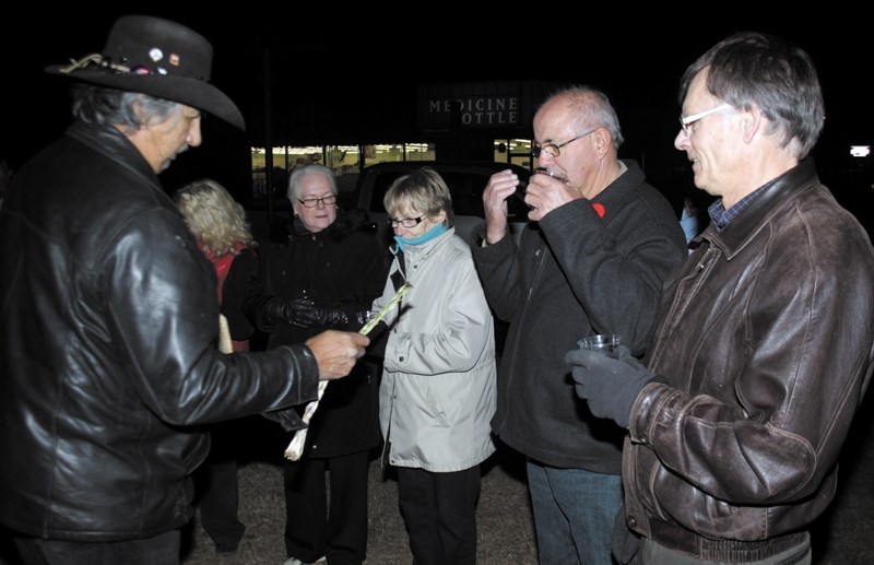 Woodlands Cree elder Alfred Beaver burned sweetgrass for participants of the candlelight vigil, including Westlock mayor Bruce Lennon (right) and Westlock County reeve