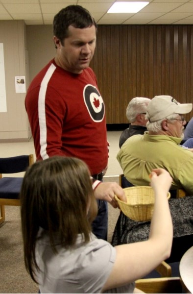 Todd Ducharme went around the crowd drawing names of prize winners at the pub night event held at the Westlock Curling Club on Wednesday, Nov. 30, which raised money for the