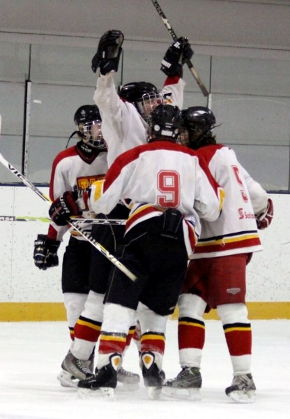 Westlock Sabres&#8217; Chase Rau celebrates his game-winning goal with teammates after defeating the Meadow Lake Storm 6-5 in overtime with just seconds left on the clock.