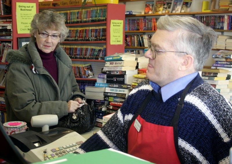 Doug Pearson rings up a sale for Barb Griffith at The Bookshelf last week. The store will close its doors after 38 years serving the community. Pearson says a dwindling