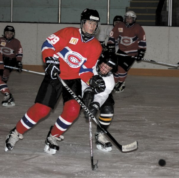 Hayden Plain slips the puck past a Neerlandia player during the Westlock Canadiens&#8217; loss Friday night at the Jubilee Arena. The Fun Hockey Association hosted a