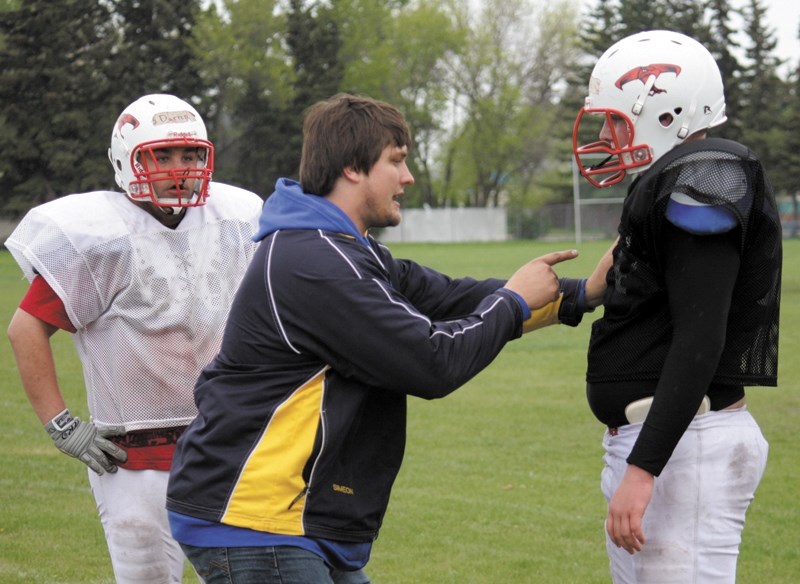 Simeon Rottier offers advice to two T-Birds during a training camp in Westlock last spring. Rottier will return to Alberta to play for the Edmonton Eskimos this season.