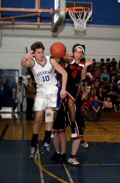 Taylor Doblanko makes a mid-air pass during the St. Mary Sharks&#8217; 65-40 victory over Warburg during their first game of the zone championships hosted in Westlock last