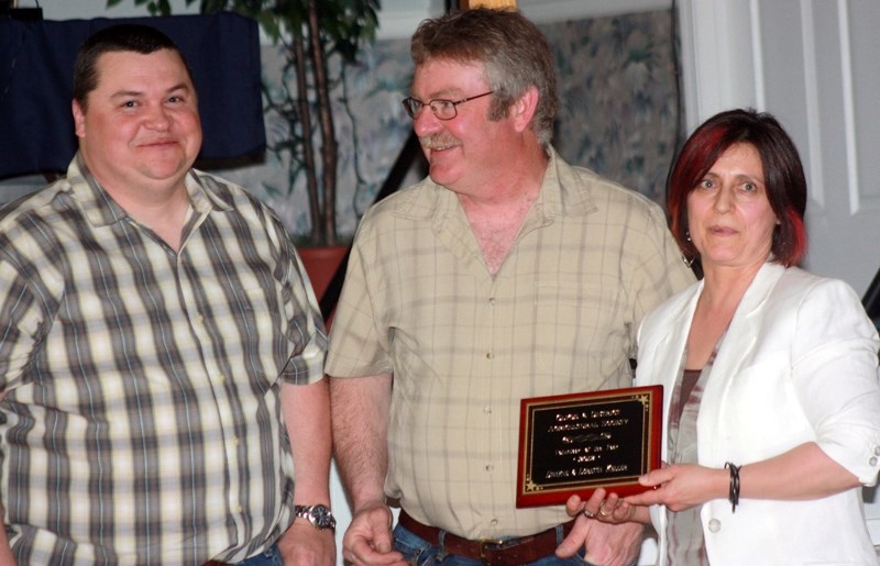 Last year&#8217;s volunteer of the year Jim Nyal (left) presented the award to 2012 winners Dwayne and Loretta Keller at the Clyde Ag 500 banquet last Saturday at the Clyde