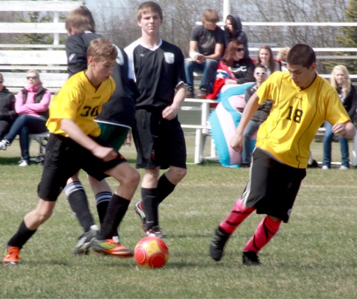 Greg Rimmer (right) watches teammate Kees Koeman move the ball up the field during the Westlock U-18 soccer team&#8217;s 7-0 loss to Athabasca Sunday afternoon.