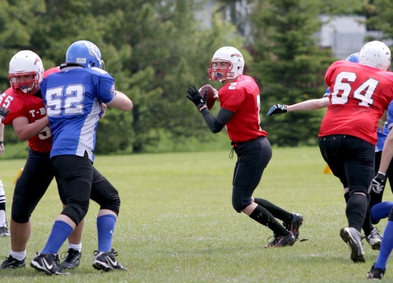 T-Birds&#8217; quarterback Brett Snell drops back to pass in the team&#8217;s first jamboree scrimmage against Peace Wapiti on May 26.