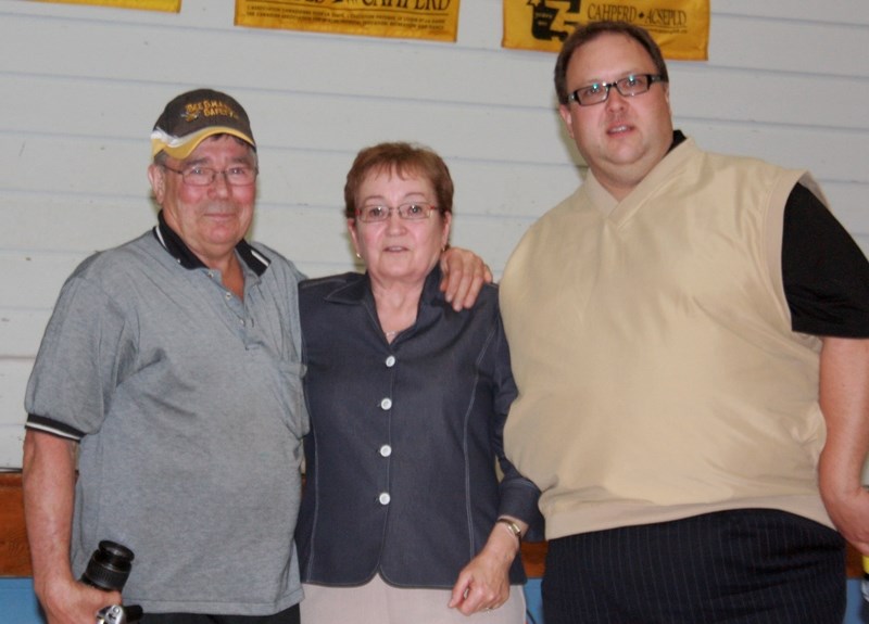 Pembina Hills school division trustee David Truckey (right) presented the Exemplary Community Partner Award to Lynn Proulx, who was accompanied by her husband Richard.