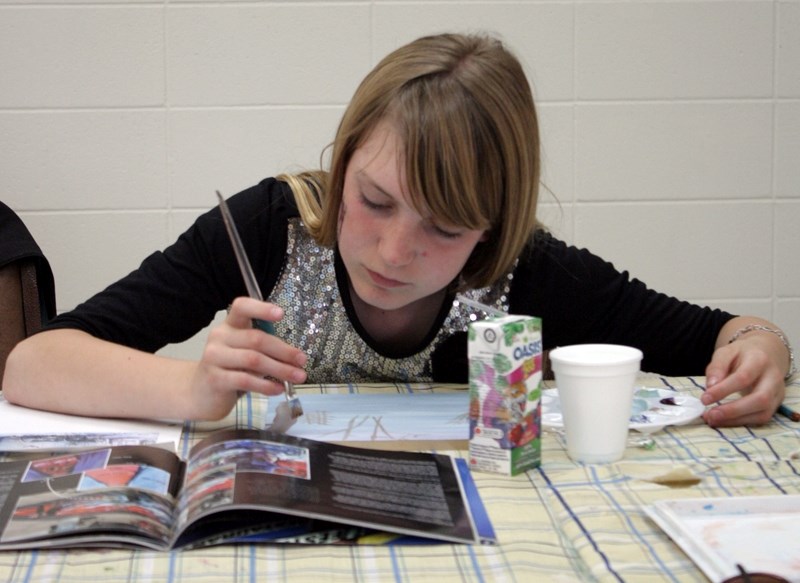 Alysha Byer works on her tile that will soon join 143 others to make a mural to hang in the Rotary Spirit Centre for years to come. Each tile will look different, but when