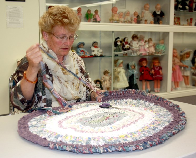 Anna Churchill demonstrates how to recycle old fabric into a rag rug during Pioneer Day at the Westlock Museum Saturday. The event had fewer visitors than usual, but the