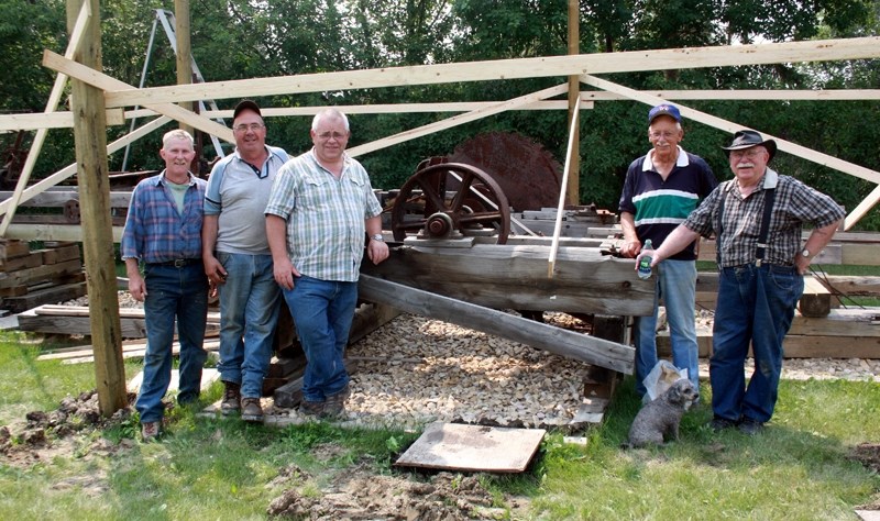 Jarvie-area residents Bob Clark (left), Art Dechaine, Percy McKinnon, Brian Gray and Jim Turnbull were busy building an old-fashioned sawmill in the hamlet last Monday