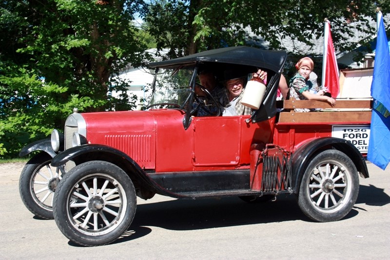 Kevin Smith entered his 1926 Model T Roadster in the parade and the show and shine, where he won first place. He is pictured here with a jug of refreshments &#8211; one would 