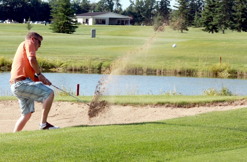 Trevor McIntyre successfully navigates his way out of a sand trap on Day 2 of the Men&#8217;s Open at the Westlock Golf Club last weekend.