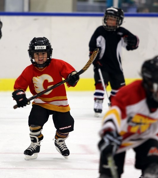 Kodey Todd, 5, is all smiles as he skates up the ice during a drill at the I Love Hockey event Saturday at the Spirit Centre.