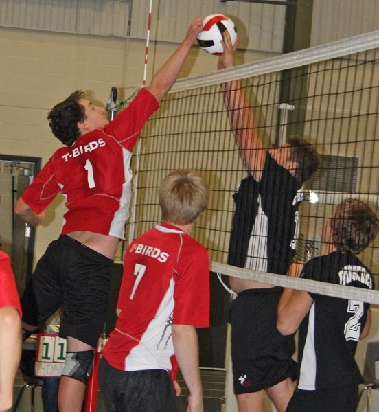 R.F. Staples’ Chase Rau (left) gets a hand on the volleyball during the team’s win over Boyle during the round-robin of a weekend tournament in Athabasca, in which the