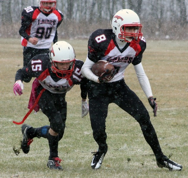 Westlock’s Josh Dittmer (8) looks for a seam to run the ball while followed by teammate Kash McCotter (15) last Saturday in Athabasca.