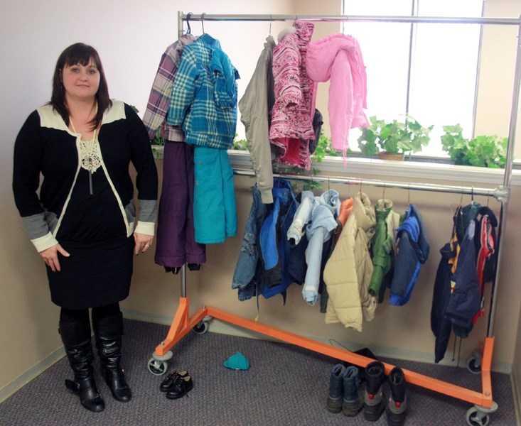 FCSS Director Jayme Baxter stands next to the sparse selection of kids’ coats available through the Coats for Kids program in Westlock. Donations of coats, toques, gloves,