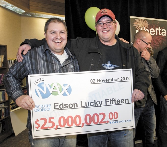 Jarvie’s Dustin Gibson (L) and Tristan Hodge were all smiles Friday when they collected their $1.6 million cheques. The pair were part of the Edson Lucky Fifteen that won the 