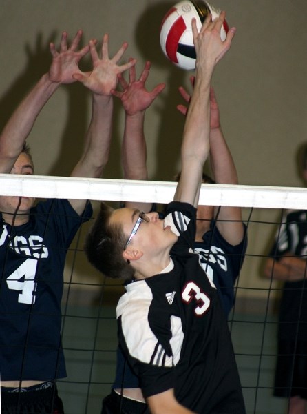 Bobby Hertz-Kleptow jumps to tip the ball over the net during the T-Birds match-up with the Barrhead Jags at the divisionals on Wednesday.