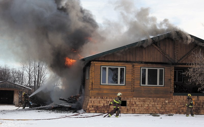Westlock Rural firefighters work to put out the chimney fire that spread to the rest of Andy Luchka’s house west of town on Nov. 15. By the time firefighters arrived, the