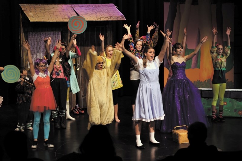 The Wicked Witch of the East now dead, the Munchkins celebrate with Toto (Nathanael Tabert), Dorothy (Hannah Tabert) and Glinda the Good Witch (Ashley Chayka).