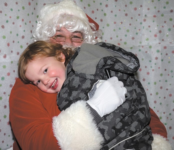Kolby Plant, 4, shows his love for Santa at the SAAN store during Light Up.