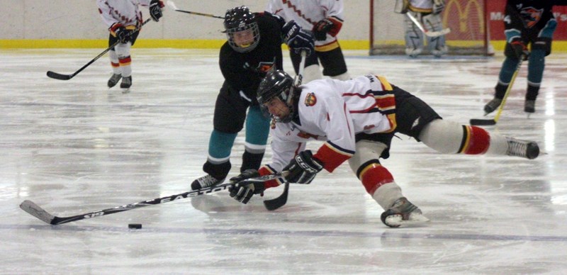 Nick Schwartz gets tripped up at the blue line during the Westlock Bantam Warriors’ 7-0 win over Warburg last Saturday at the Westlock Rotary Spirit Centre. Three goals in