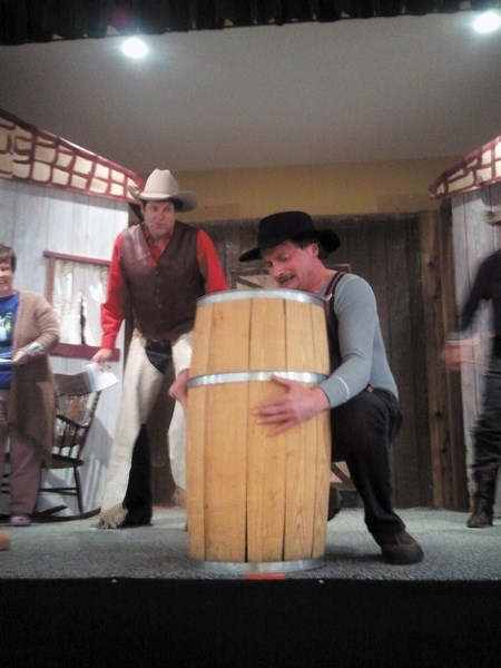 Dirty Dan (Jeff Zeise) attempts to hoist a barrel while Pecos Bill (played by Ted Brooks) eggs him on. Pecos Bill and Slue-Foot Sue Meet the Dirty Dan Gang will run from Feb. 