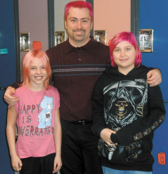 Eleanor Hall School principal Don Hinks with students Payton Pecek (left) and Elora Charabin. The three are proudly sporting pink hairdos to help raise money and awareness as 