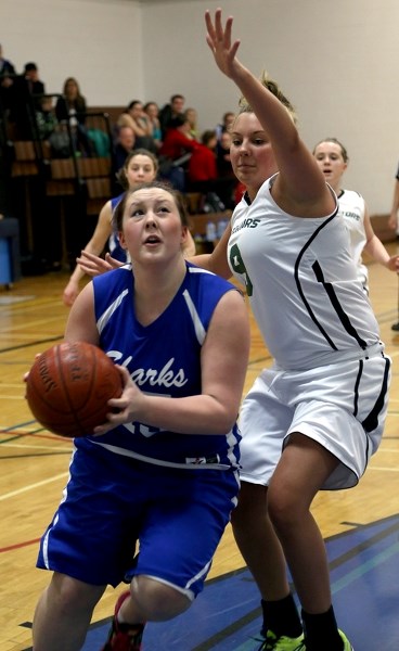 St. Mary Shark Kellie Calladine drives to the basket during her team’s 68-52 loss to the Edwin Parr JV Predators on Feb. 23. The Sharks were hosting the 2013 edition of the