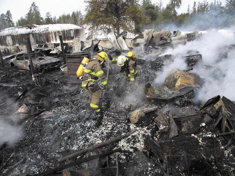 Westlock County firefighters at the scene of a Saturday-morning fire southeast of Clyde. No one was hurt in the March 30 blaze that destroyed not only a loft, but seven