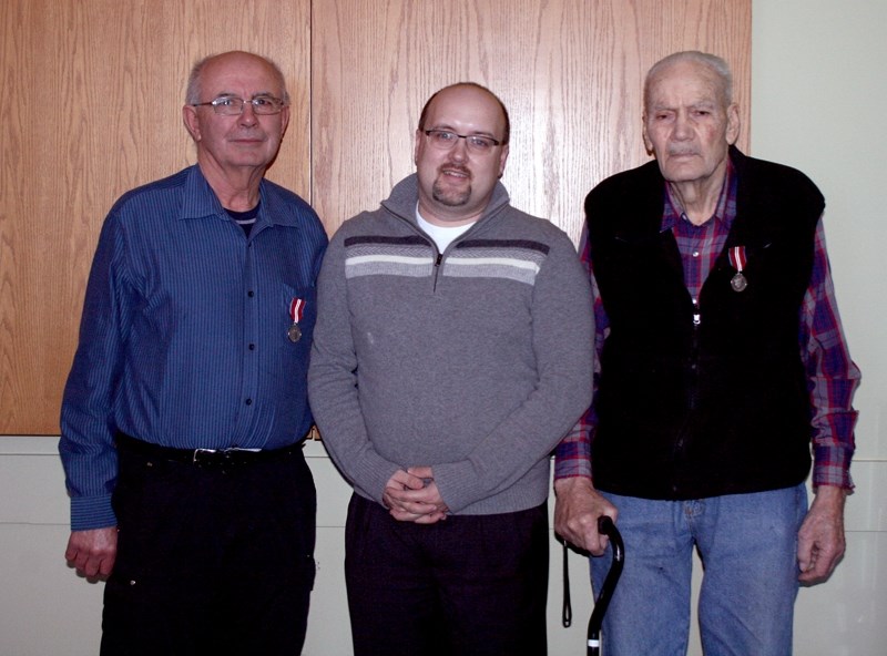 Westlock-St. Paul MP Brian Storseth (centre) presented Westlock County reeve Charles Navratil (left) and Bill Seatter their Diamond Jubilee Medals at a special ceremony on
