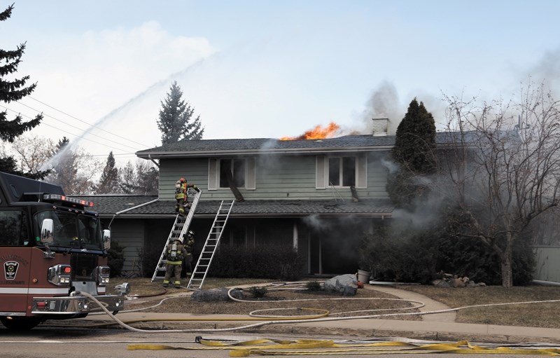 Firefighters battle a blaze that tore through a home on 100 Avenue at 104 Street in downtown Westlock last Tuesday. The fire is believed to be deliberately set, and three
