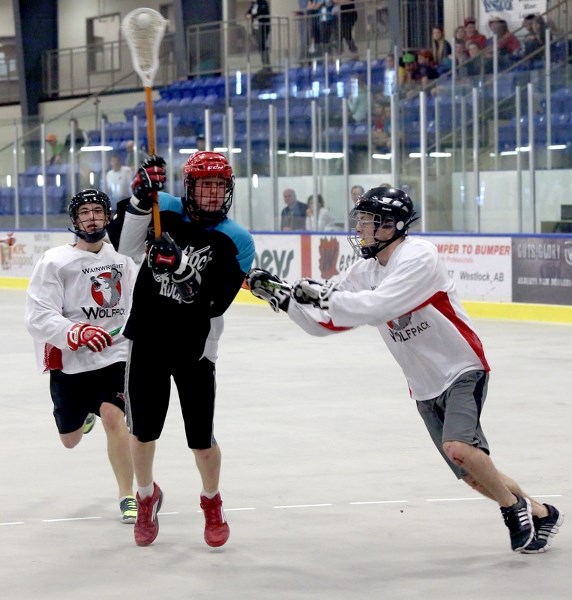 Westlock junior Rock Kellan Cornellis fires a shot on goal against two Wainwright Wolfpack defenders. Cornellis had a hat trick and two assists to lead the Rock to a 15-8