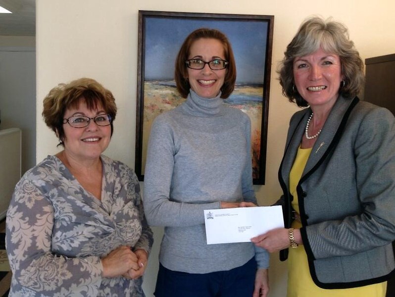 Westlock Blooms Foundation president Shirley Toporowski (centre) and Blooms’ Terry Rains (left) accepted a $15,000 grant on behalf of the club from