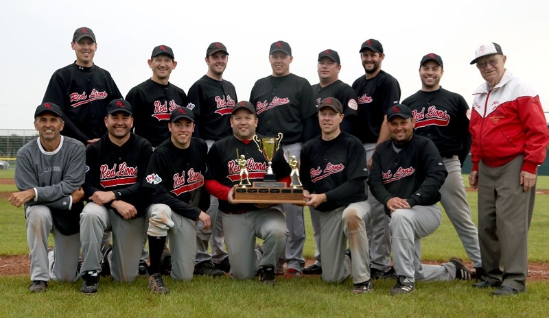 Westlock’s Grey Lions celebrate with the Harvey J. Doherty Memorial trophy after beating the Cold Lake Cardinals 7-6 in the tournament final on June 2 at Keller Field. BACK