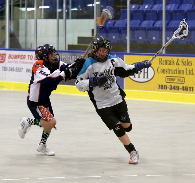 Westlock bantam Rock Britannie Ouimet maintains possession while being defended on Saturday afternoon against the Edmonton Blues. Ouimet had six points to lead the team in