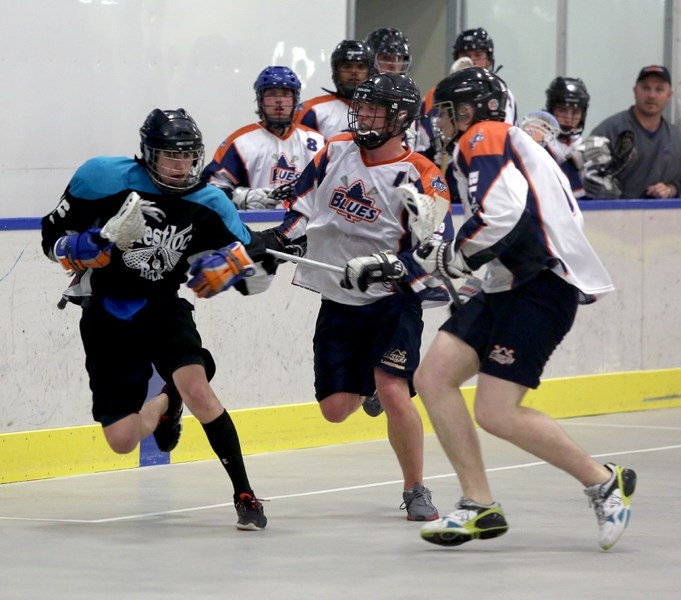 Jordan Boulerice evades two Edmonton Blues defenders on Friday evening during the Westlock junior Rock’s 12-10 home win. The Rock battled hard to pull off the win, overcoming 