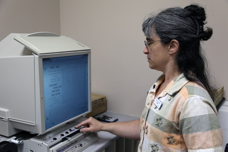 Westlock Library acquisitions and cataloging employee Carey Whistance-Smith demonstrates how the Westlock News’ new microfilm machine operates. The unit was recently given to 