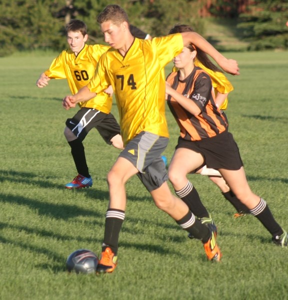 Kees Koeman moves the ball down the field during a game between the Westlock U-16 team and Morinville at the field behind Westlock Elementary School on Thursday night.