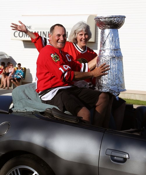 Jim Rau and Barb Carbert celebrate the Chicago Blackhawks’ 2013 Stanley Cup win during the village of Clyde’s Canada Day parade.